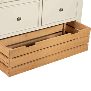 Wooden drawers being pulled out from a white cabinet.