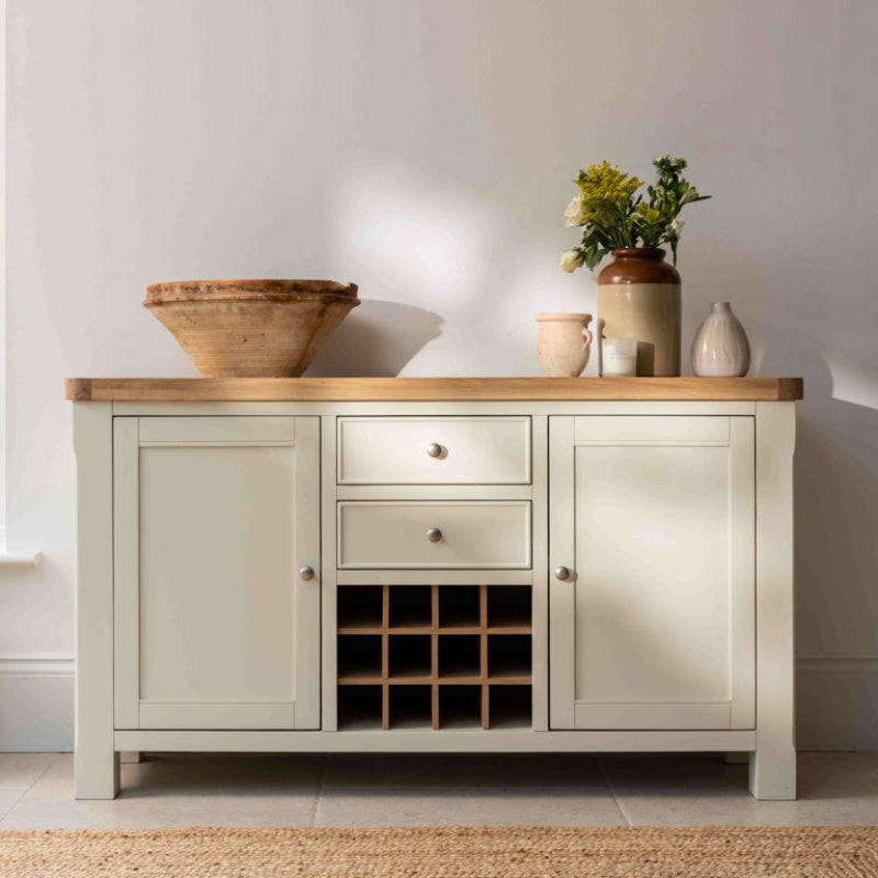 White sideboard with wooden top and wine rack on a white background