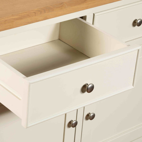 Open drawer of a kitchen cabinet with wooden top