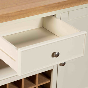 White kitchen cabinet with an open drawer and wine rack.