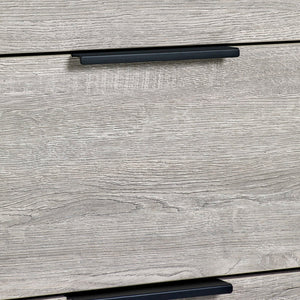 Close-up of a wooden drawer with a black handle