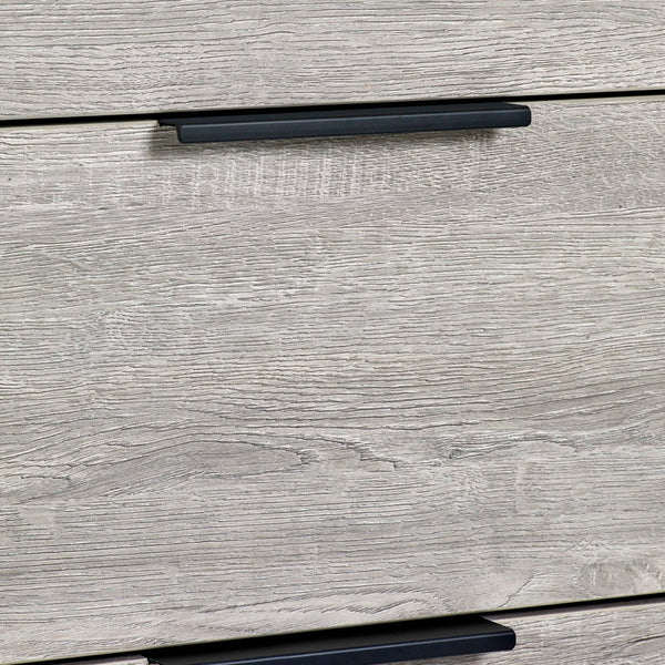 Close-up of a wooden drawer with a black handle