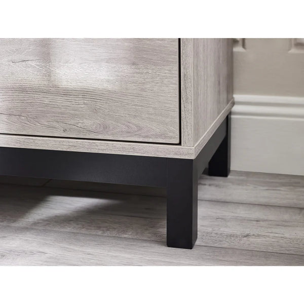 Wooden cabinet with black legs on a wooden floor