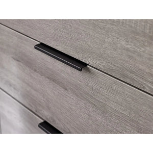 Close-up of a wooden drawer with a black handle on a white background