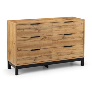 Wooden dresser with multiple drawers on a white background