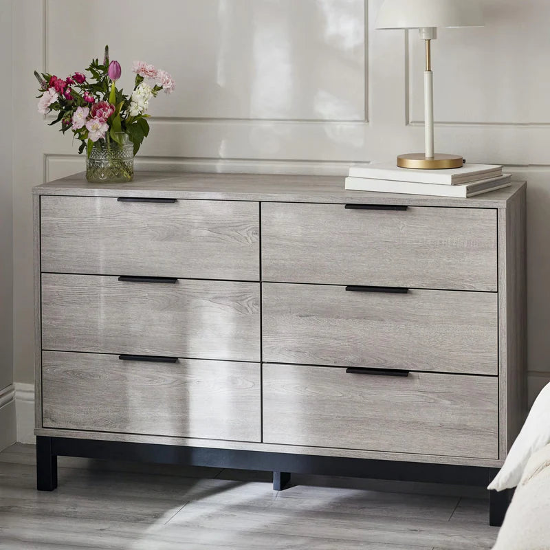 Gray dresser with six drawers on a white background