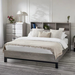 Bedroom with a wooden bed frame, white bedding, and a nightstand.