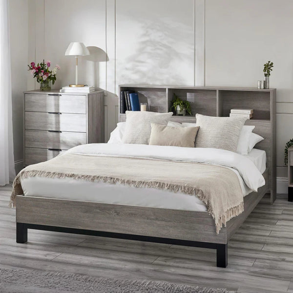 Bedroom with a wooden bed frame, white bedding, and a nightstand.