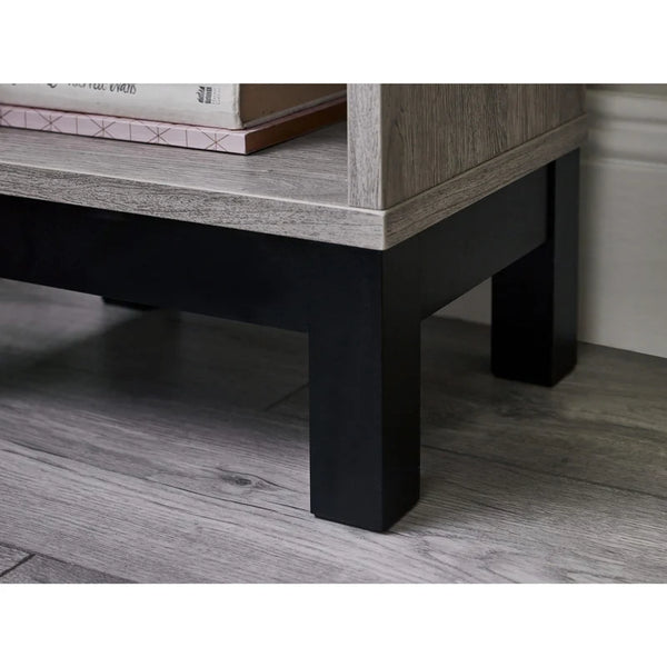 Wooden coffee table with black legs on a wooden floor