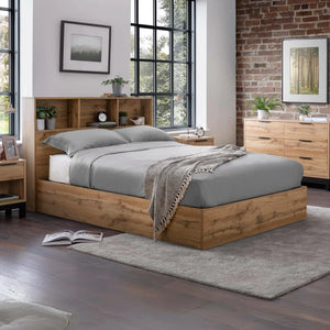 Wooden bed with gray bedding in a modern bedroom setting.