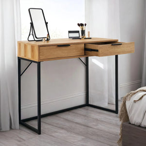 Wooden vanity table with black metal legs in a room setting.