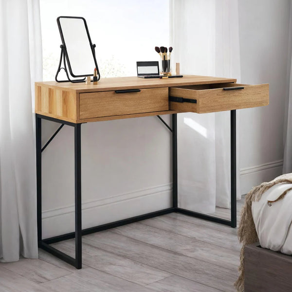 Wooden vanity table with black metal legs in a room setting.