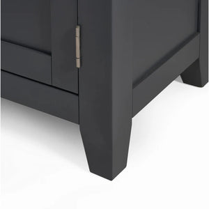 Close-up of a dark gray cabinet corner with a visible hinge on a white background