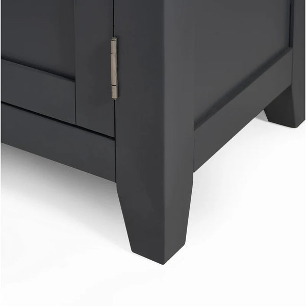 Close-up of a dark gray cabinet corner with a visible hinge on a white background