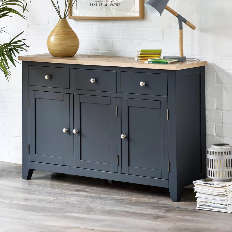 Dark gray sideboard with a light wood top on a white background