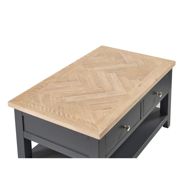 Wooden coffee table with herringbone pattern on a white background