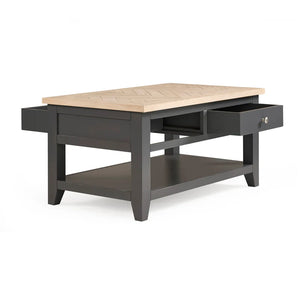 Coffee table with wooden top and black base on a white background