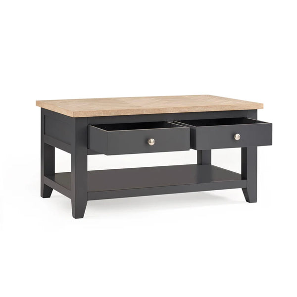 Coffee table with wooden top and dark gray base on a white background
