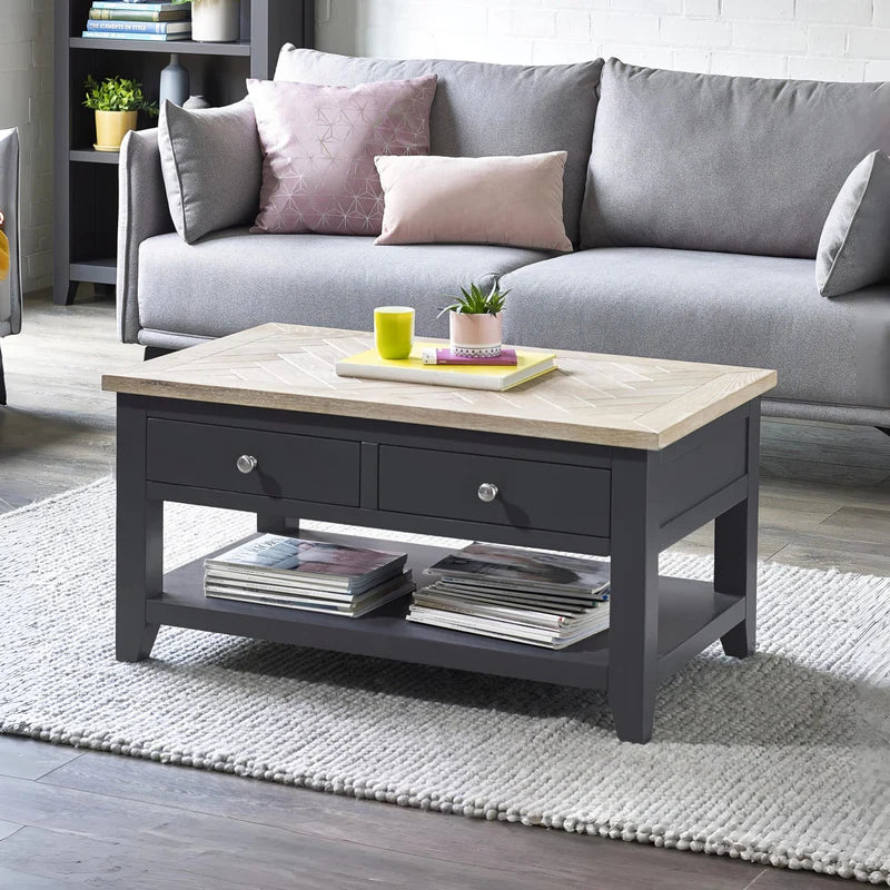 Wooden coffee table with dark gray base on a white background