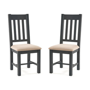 Two grey wooden chairs with beige cushioned seats on a white background