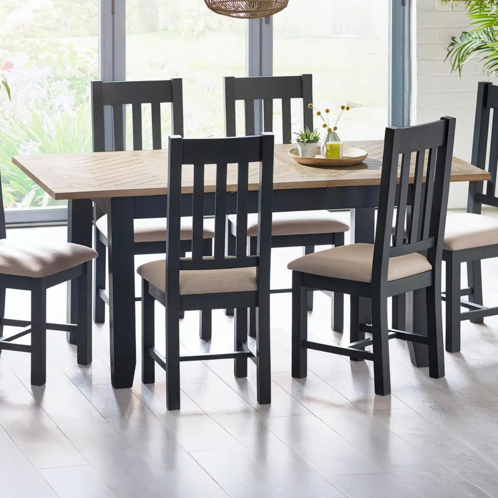 Rectangular table with wooden top and grey legs on a white background