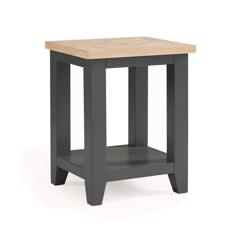 Small square table with a wooden top and dark gray base on a white background