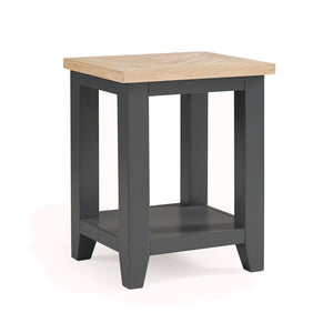 Small square table with a wooden top and dark gray base on a white background