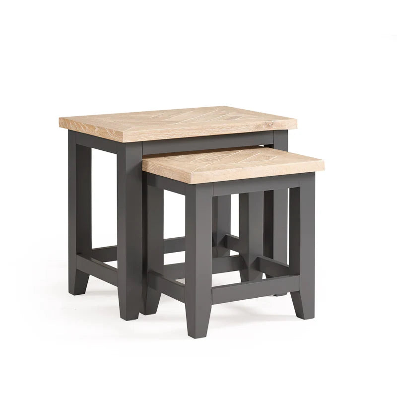 Set of two nesting tables with wooden tops and black frames on a white background