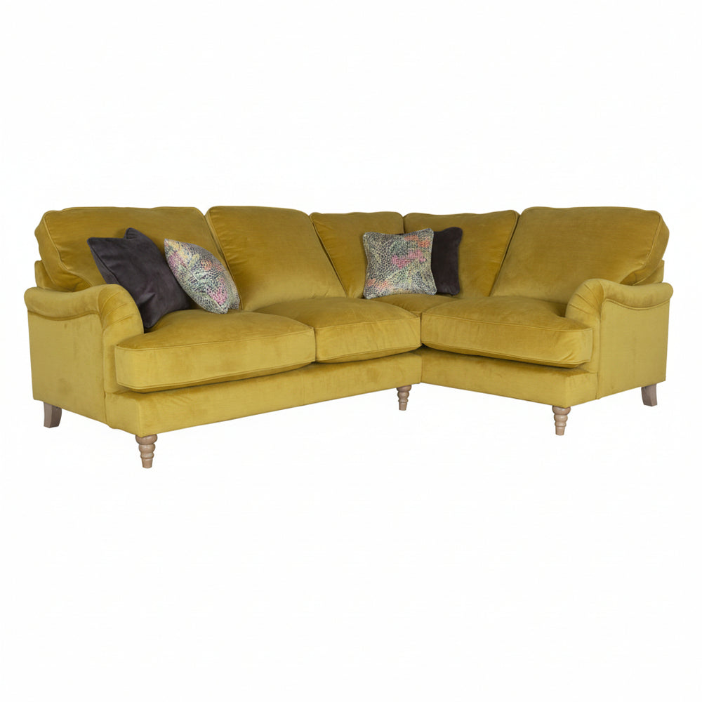Yellow sectional sofa with decorative pillows on a white background