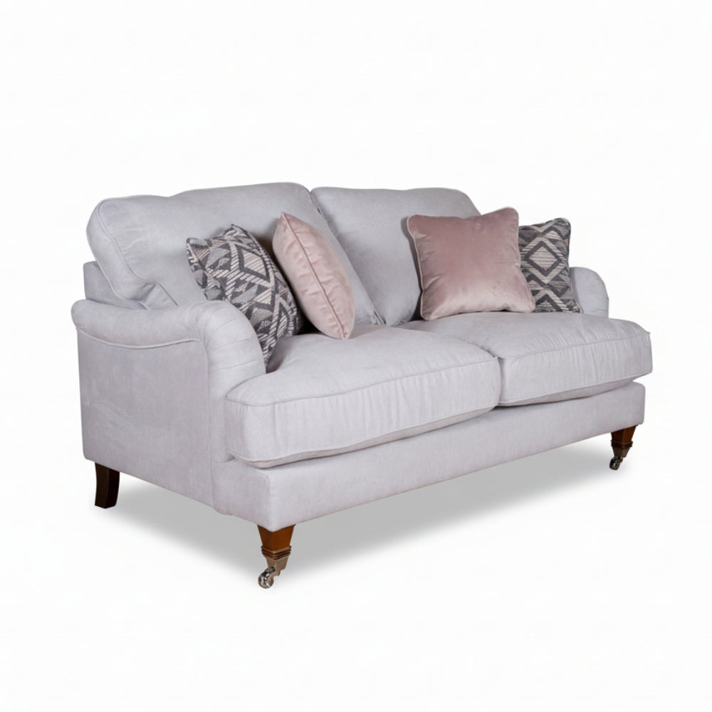 Light gray sofa with decorative pillows on a white background
