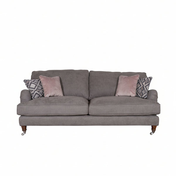 Gray sofa with patterned and solid color cushions on a white background