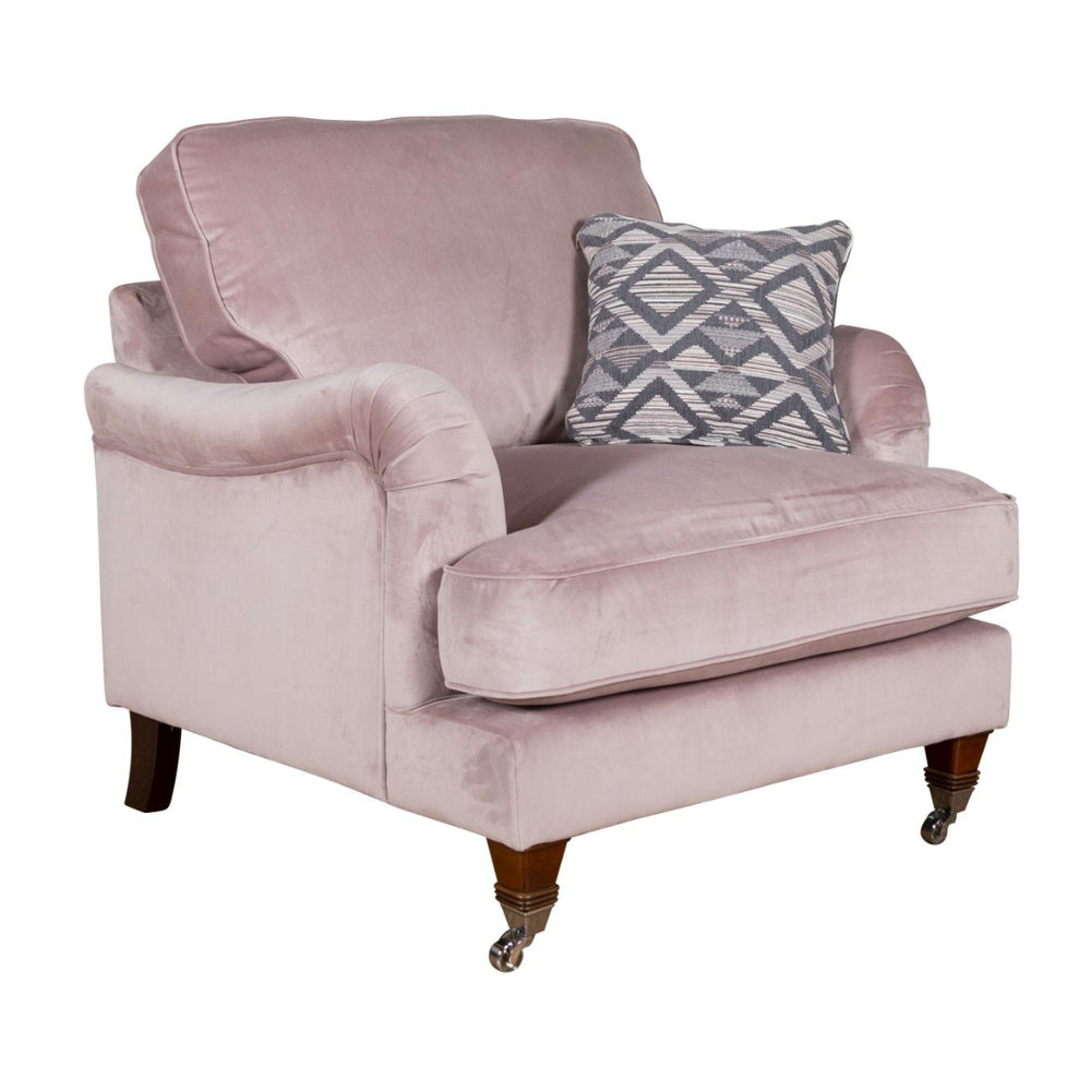 Pink armchair with a patterned pillow on a white background