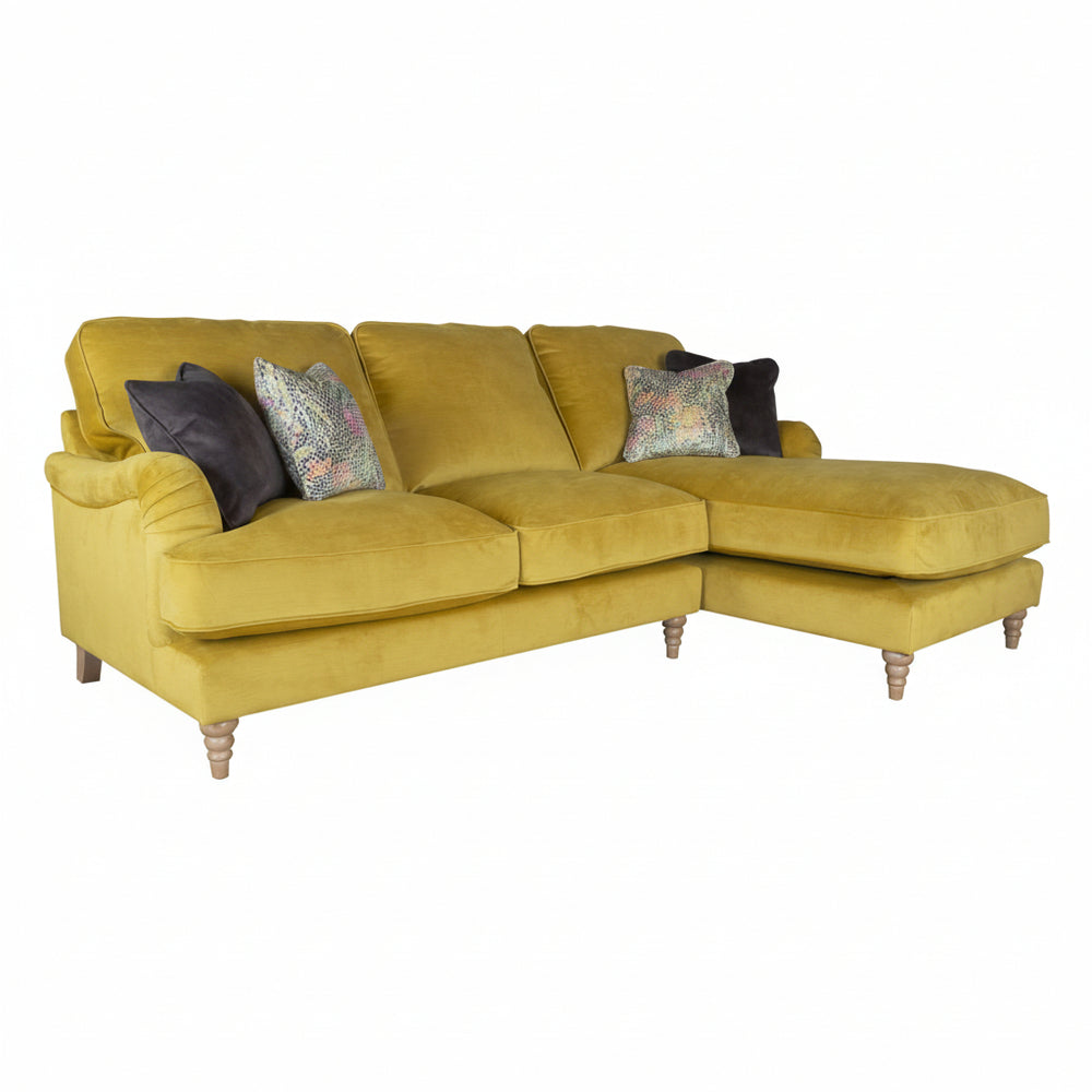 Yellow sectional sofa with decorative pillows on a white background