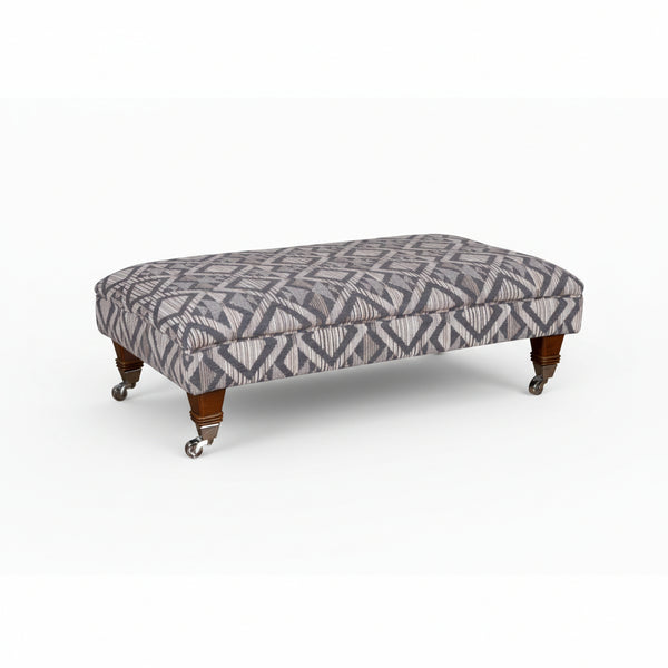 Patterned ottoman with wooden legs on a white background