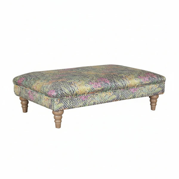 Patterned ottoman with wooden legs on a white background