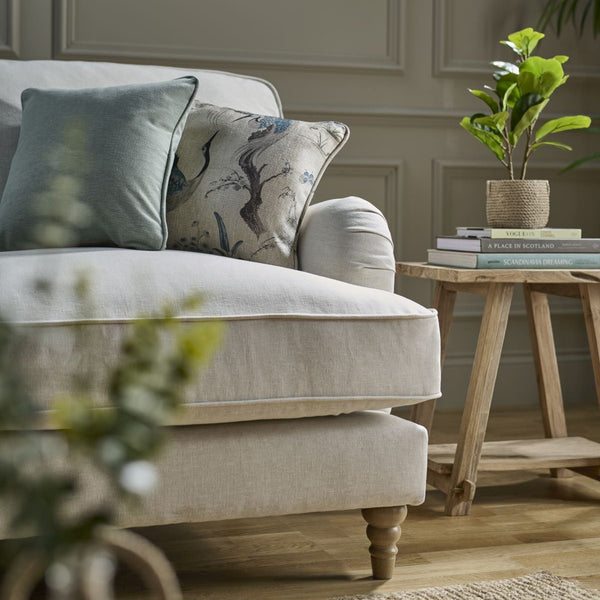 Beige sofa with decorative pillows in a living room setting