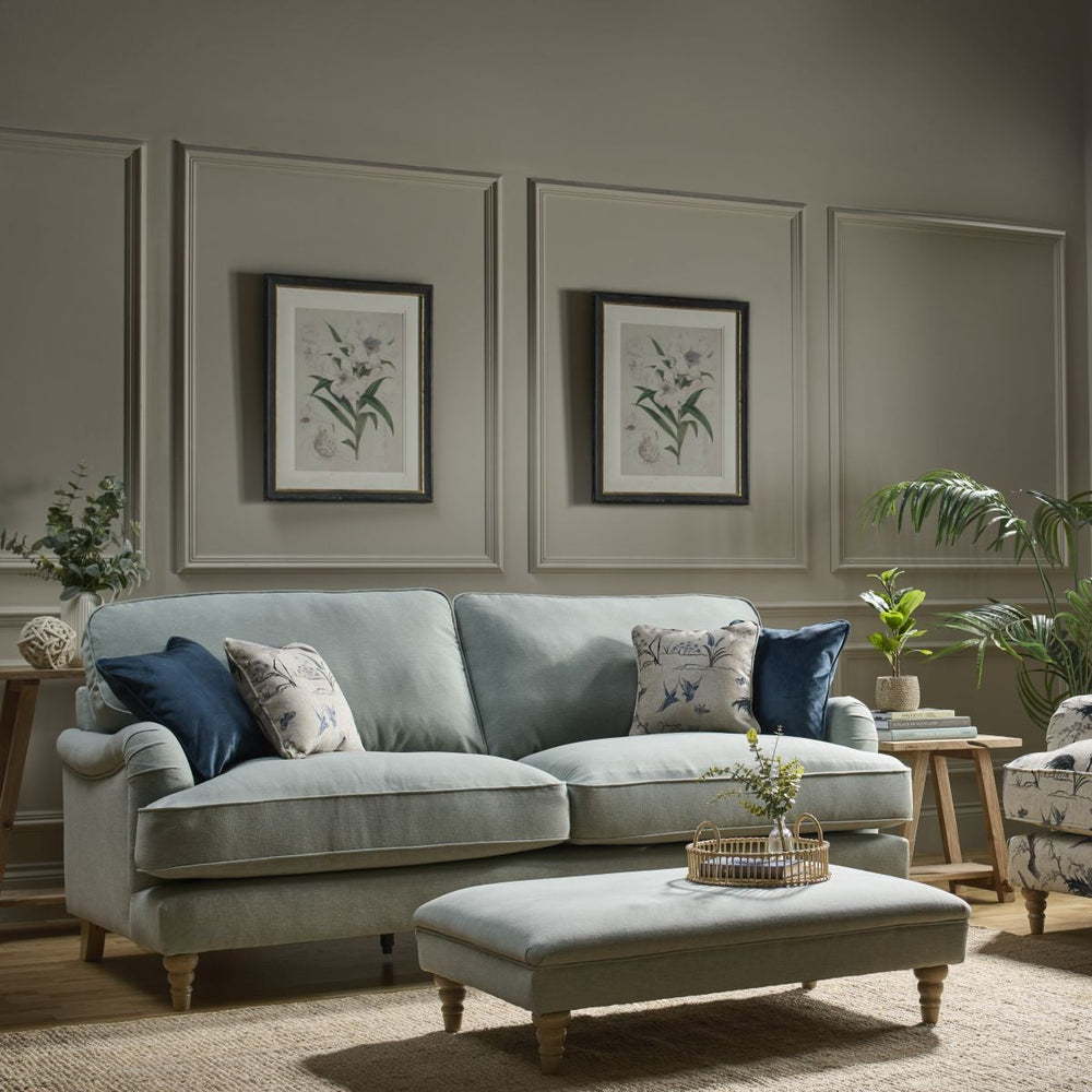 Yellow sectional sofa with decorative pillows on a white background