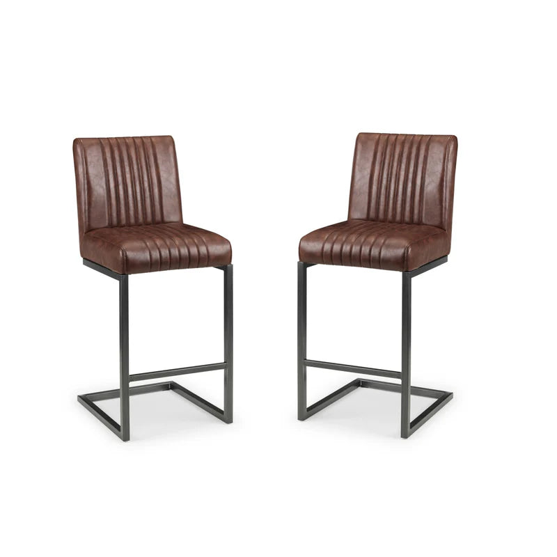 Two brown leather bar stools with metal legs on a white background