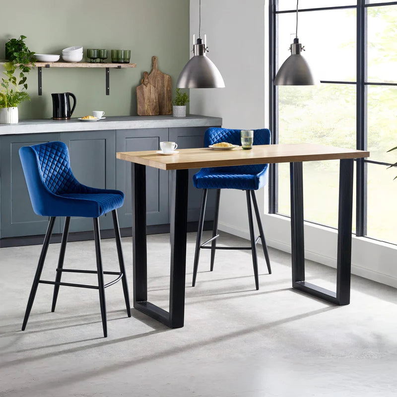 Bar table with wooden top and black metal legs on a white background