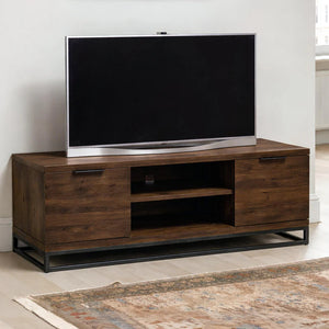 Wooden TV stand with a television on top in a room setting.