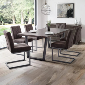 Dining room with a modern table and chairs in a well-lit room.