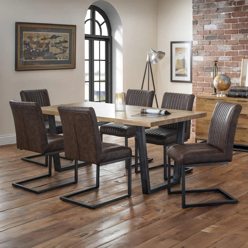 Two brown leather chairs with metal frames on a white background