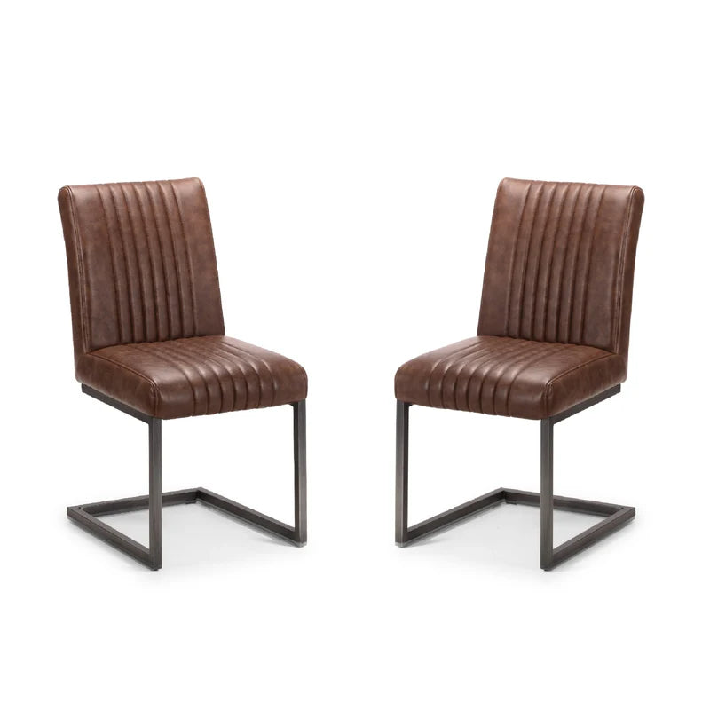 Two brown leather chairs with metal frames on a white background