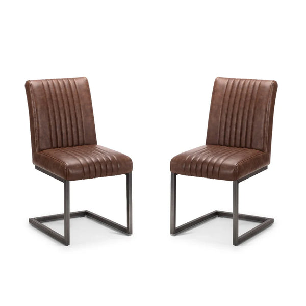 Two brown leather chairs with metal frames on a white background