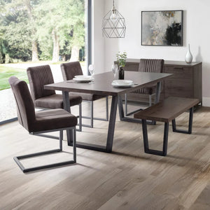 Dining room with a wooden table and chairs on a wooden floor.