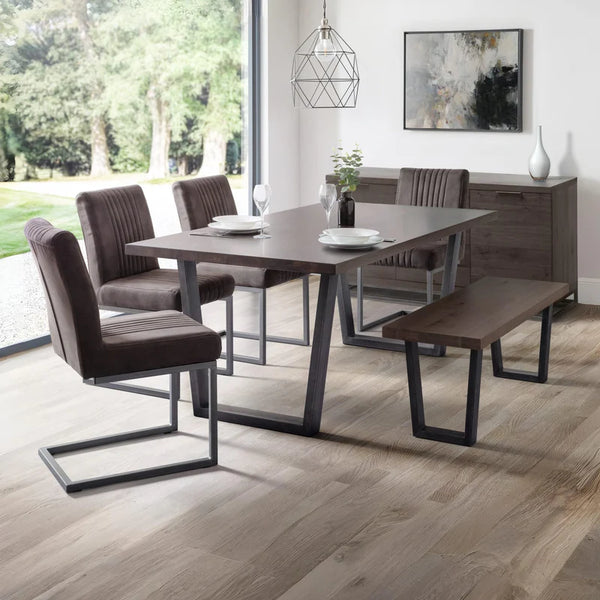 Dining room with a wooden table and chairs on a wooden floor.