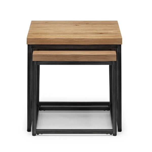 Set of two wooden nesting tables with black metal legs on a white background