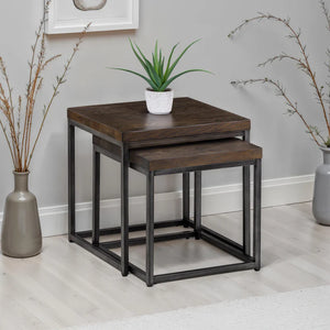 Set of two wooden nesting tables with metal legs in a room setting.