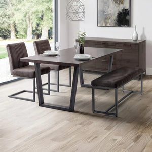 Dining room set with table, chairs, and bench in a modern interior.
