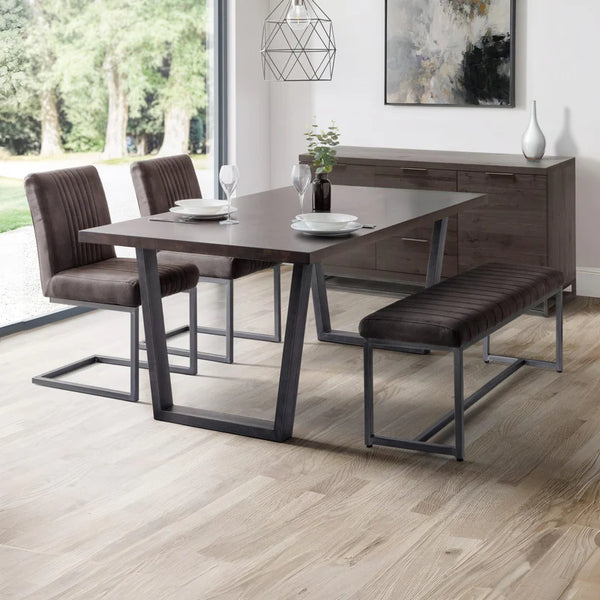 Dining room set with table, chairs, and bench in a modern interior.